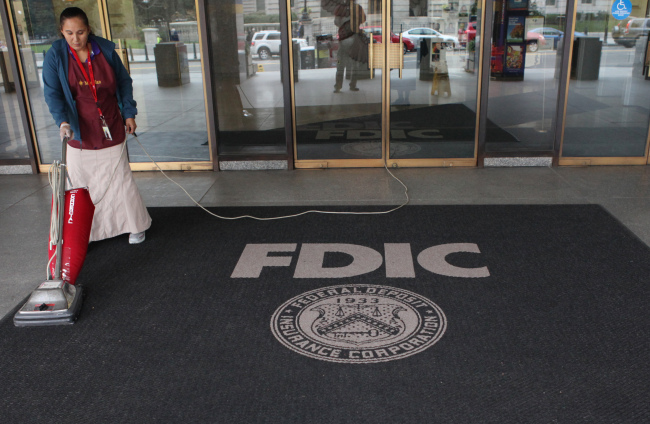 A worker vacuums a rug outside the Federal Deposit Insurance Corp. (FDIC) headquarters in Washington, D.C., U.S., on Tuesday, Oct. 9, 2012. U.S. banks with assets from $10 billion to $50 billion will get until next year to begin self-administered stress tests under FDIC rules approved today. Photo: Rich Clement/Bloomberg
The Federal Deposit Insurance Corp. headquarters in Washington, D.C.   Bloomberg