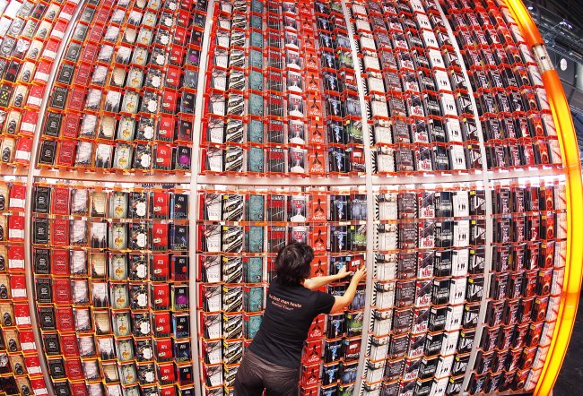 A woman arranges books on a shelf at the Frankfurt Book Fair in Frankfurt, Germany, Tuesday.   AP-Yonhap News