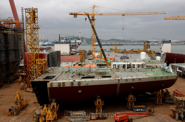 A ship is under construction in the dry dock at the Hyundai Heavy Industries shipyard in Ulsan.    Bloomberg