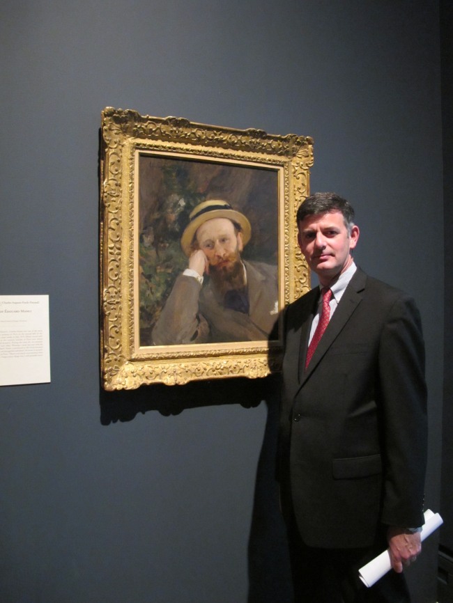 Brian Kennedy, director of the Toledo Museum of Art, poses in front of a portrait of French Impressionist Edouard Manet, on Oct. 3 in Toledo, Ohio.    AP-Yonhap News