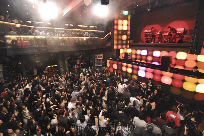 Clubbers at Club OCTAGON dance to the music of the house DJ.   Club OCTAGON
