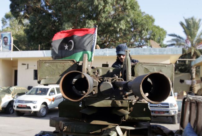 A Libyan soldier sits on an armed vehicle flying the national flag in the coastal city of Benghazi on Sunday.   AFP-Yonhap News