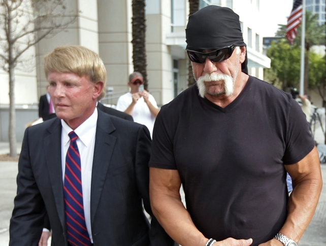 Reality TV star and former pro wrestler Hulk Hogan, right, whose real name is Terry Bollea, leaves the United States Courthouse with his attorney David Houston after a news conference Monday. (AP-Yonhap News)