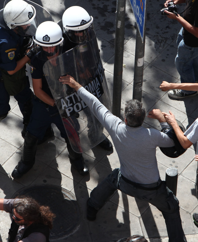 Protesters clash with riot police in Athens, during a 24-hour nationwide general strike on Thursday.   AP-Yonhap News