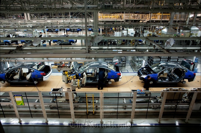 Assembly line employees work on the Yuedong compact at a Hyundai factory in Beijing.   Hyundai Motor