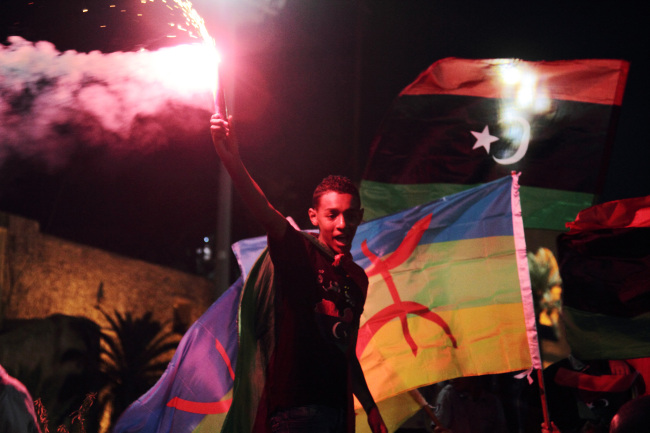 Libyans celebrate one year on since the country was declared liberated from former dictator Moammar Gadhafi, at Martyrs Square in Tripoli on Tuesday.   AP-Yonhap News