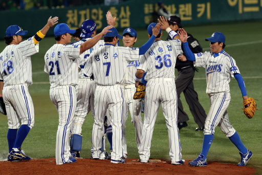 Samsung Lions Players congratulate each other after beating SK Wyverns 3-1 in the first game of the Korean Series at Daegu Baseball Stadium on Wednesday.  Yonhap News
　