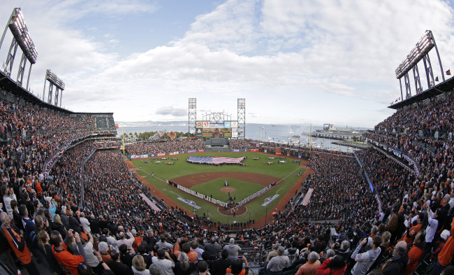In this photo shot with a fisheye lens, Phillip Phillips sings the national anthem before the start of Game 1 of baseball's World Series between the San Francisco Giants and Detroit Tigers Wednesday, Oct. 24, 2012, in San Francisco. (AP)