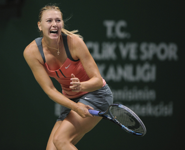 Maria Sharapova of Russia reacts as she returns a shot to Samantha Stosur of Australia during their tennis match on the fourth day of the WTA championship in Istanbul on Friday.   AP-Yonhap News