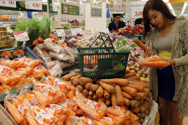A shopper buys goods at a supermarket in Seoul.   Yonhap News