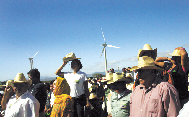 In this Jan. 22, 2009, file photo, people watch during the inauguration of a new $550 million wind farm project in La Ventosa, Mexico, located on the narrow isthmus between the Gulf of Mexico and the Pacific Ocean. Mexican President Felipe Calderon has made the inauguration of wind parks one of the main focuses
of his administration’s ambitious pledge to cut Mexico’s carbon emissions by 30 percent by 2020. (AP)