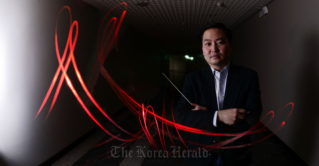 Conductor Hogen Yun poses at the Sejong Center for the Performing Arts in Seoul on Tuesday.   Park Hae-mook/The Korea Herald