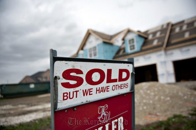 A “Sold” sign stands outside a new home in Peoria, Illinois.    Bloomberg