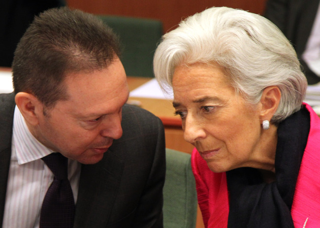 International Monetary Fund managing director Christine Lagarde (right) talks with Greek Finance Minister Yannis Stournaras, during the Eurogroup finance ministers meeting in Brussels on Monday.   AP-Yonhap News