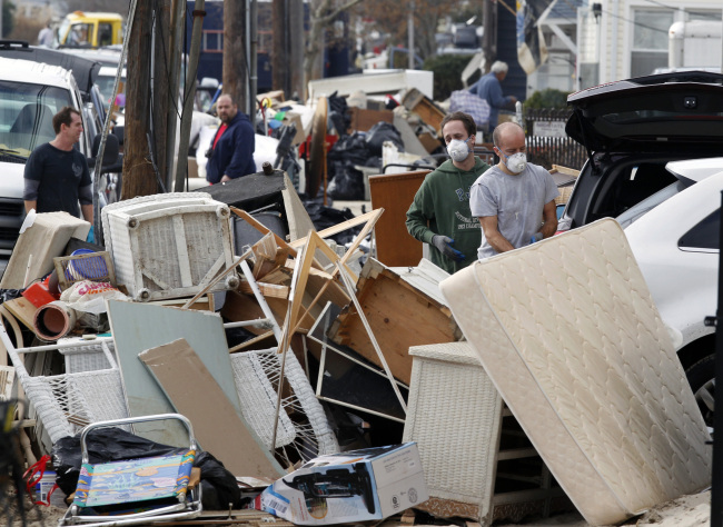 People throw away furniture and other ruined items in Seaside Heights, New Jersey, after residents of Seaside Heights were allowed back in their homes for a few hours Monday, two weeks after the region was pounded by Superstorm Sandy.   AP-Yonhap News