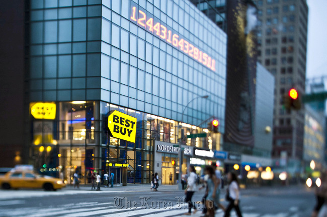 Pedestrians pass in front of a Best Buy Co. store in New York.   Bloomberg
