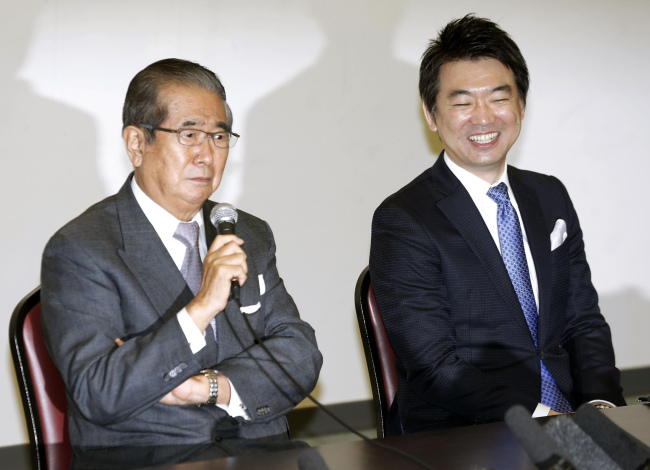 Japan Restoration Party’s leader Shintaro Ishihara (left) and its acting leader Toru Hashimoto appear at a news conference after they formed a national political party in Osaka, western Japan, Saturday.   AP-Yonhap News
