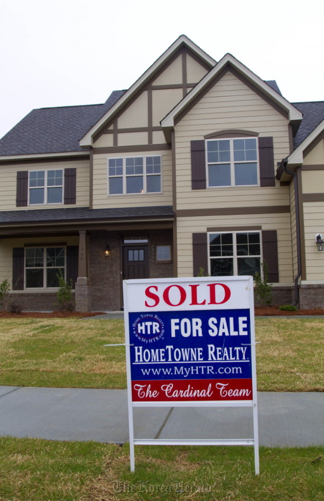 A sold sticker is displayed on a for sale sign outside of a home in Garner, North Carolina.    Bloomberg