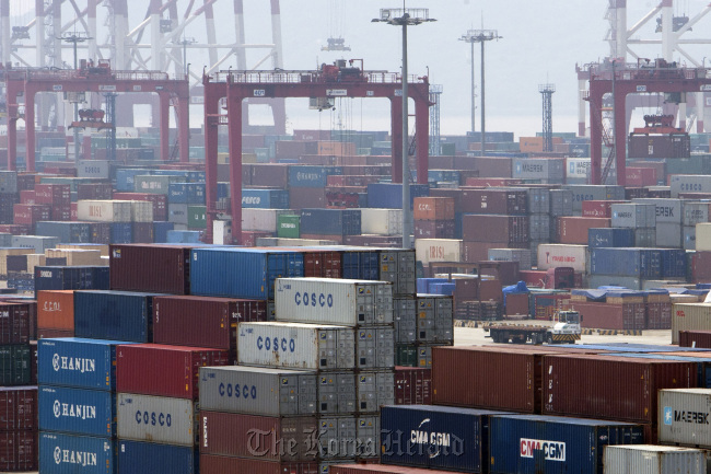Shipping containers are stacked at the Yangshan Deep Water Port in Shanghai.    Bloomberg