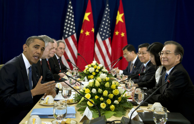 U.S. President Barack Obama (left) speaks as he meets with Chinese Premier Wen Jiabao (right) during the East Asia Summit at the Peace Palace in Phnom Penh on Tuesday.   AP-Yonhap News