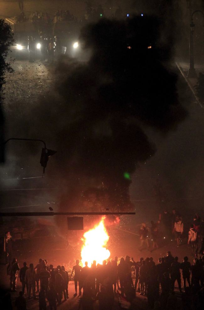 Demonstrators set fire during clashes at Tahrir Square in Cairo November 23, 2012. Angry youths hurled rocks at security forces and burned a police truck as thousands gathered in central Cairo to protest at Egyptian President Mohamed Mursi's decision to grab sweeping new powers. Police fired tear gas near Tahrir Square, heart of the 2011 uprising that toppled Hosni Mubarak at the height of the Arab Spring. Thousands demanded that Mursi should quit and accused him of launching a "coup". (Yonhap)