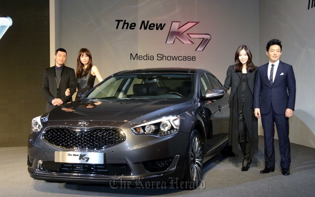 Actors of the upcoming drama “IRIS II” pose with Kia Motors’ New K7 during the car’s launching event at a Seoul hotel on Nov. 13.   Kia Motors