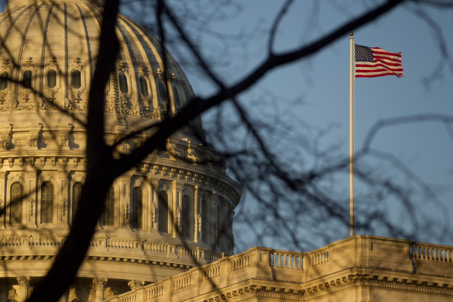 A U.S. flag flies outside the Capitol building in Washington, D.C.   Bloomberg