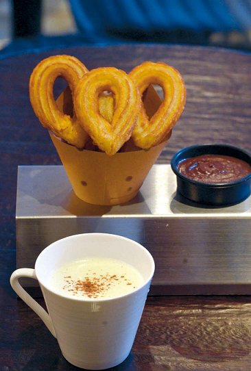 Korean cafe-style churros freshly fried and served in a brown paper cone at One Chu in Sinsa-dong, Seoul