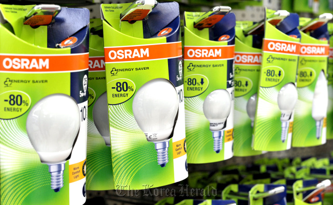 Osram energy saving bulbs sit on display at a hardware store in Munich.   Bloomberg