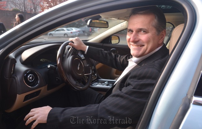 Chris Kenneally, president of Tetra Pak Korea, poses behind the wheel of 2012 Jaguar XJ Porfolio LWB at a Seoul hotel last week.   Lee Sang-sub/The Korea Herald