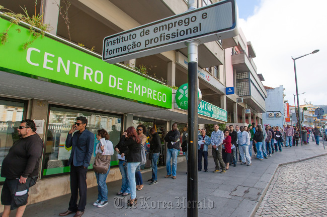 Jobseekers queue outside an employment center in Sintra, Portugal.   Bloomberg
Jobseekers queue outside an employment center in Sintra, Portugal.   Bloomberg