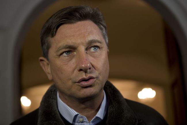 Slovenia's former prime minister Borut Pahor talks to the media outside a polling station in Sempeter, Slovenia, Sunday, Dec. 2, 2012. (AP)