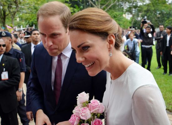 Britain's Prince William and his wife Kate smile to the public during a walk through a central city park in Kuala Lumpur, Malaysia. (AP)