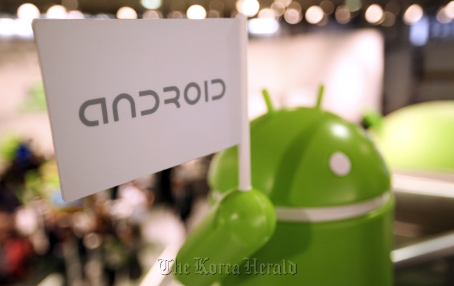 A model of the Android operating system logo stands on display at the company’s booth at the Mobile World Congress in Barcelona.   Bloomberg