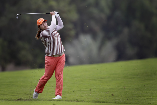 Feng Shanshan from China eyes her ball on the 18th hole during the second round of Dubai Ladies Masters golf tournament in Dubai on Thursday.   AP-Yonhap News
