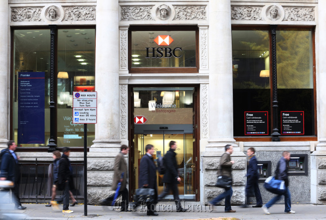 Pedestrians pass a HSBC Holdings Plc bank branch in London.   Bloomberg