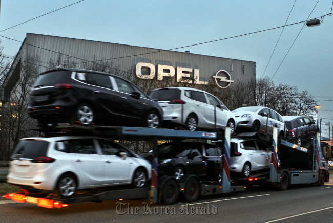 A car transporter loaded with automobiles leaves the General Motor Co.’s Opel plant in Bochum.    Bloomberg