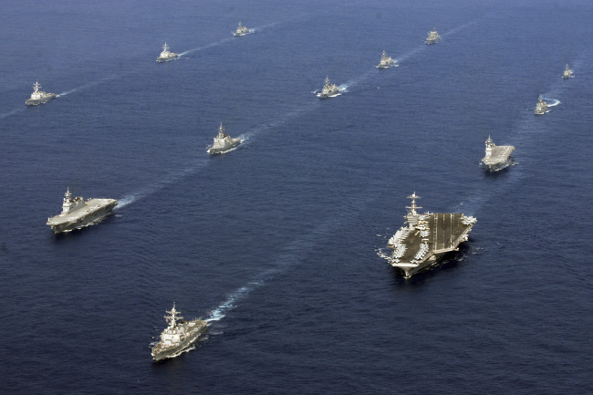 Twenty-six ships from the U.S. Navy and the Japan Maritime Self-Defense Force, including USS George Washington (bottom right) steam together in East China Sea after the conclusion of Keen Sword, a biennial naval exercise by the two countries to practice their response to a crisis in the Asia-Pacific region.    AP-Yonhap News
