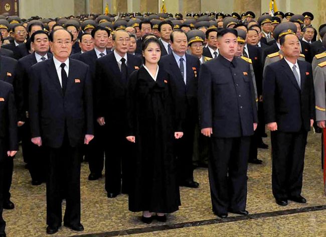 This photo taken by North Korea’s official Korean Central News Agency on Monday shows North Korean leader Kim Jong-un accompanied by his wife Ro Sol-ju and senior officials of the party and North Korean Army paying respect to late leader Kim Jong-il at the Kumsusan Palace in Pyongyang for the first anniversary of his death.   AFP-Yonhap News