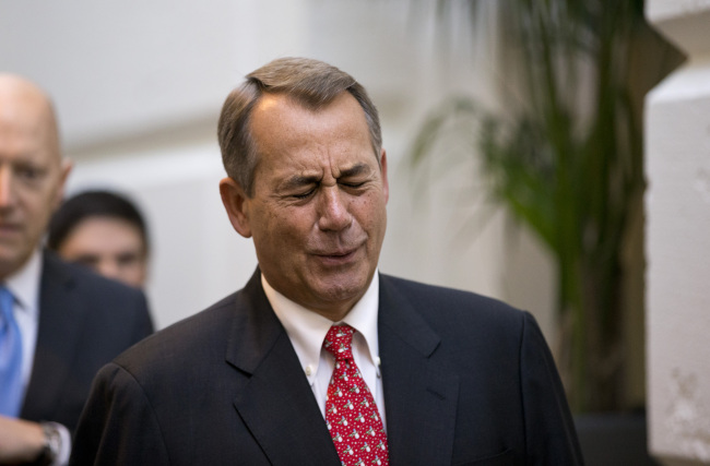 Speaker of the House John Boehner, R-Ohio, winces while talking to a reporter on the way to a closed-door meeting with House Republicans as he negotiates with President Obama to avert the fiscal cliff, at the Capitol in Washington on Tuesday.   AP-Yonhap News