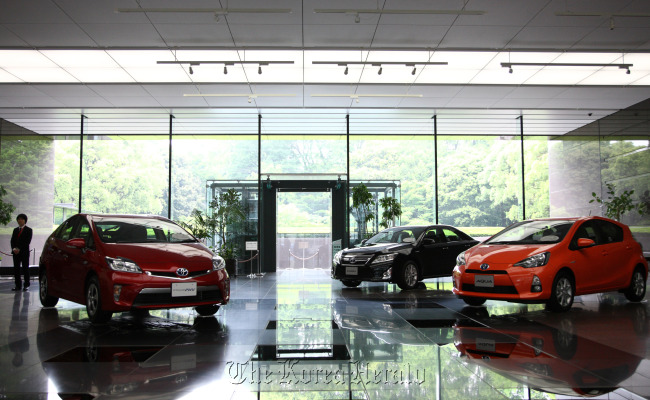 Toyota Motor Corp. Prius plug-in and Aqua hybrid vehicles are displayed at the company’s Tokyo head offices.   Bloomberg