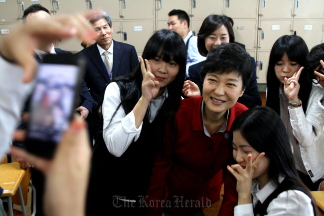 President-elect Park Geun-hye poses with students during her visit to a high school in Ulsan in October.   Saenuri Party