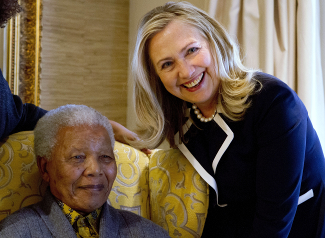 <YONHAP PHOTO-0077> FILE - In this Aug. 6, 2012 file photo, U.S. Secretary of State Hillary Rodham Clinton, right, meets with former South Africa President Nelson Mandela, 94, at his home in Qunu, South Africa. There may be no living figure so revered as Mandela around the world as a symbol of sacrifice and reconciliation, his legacy forged in the fight against apartheid, the system of white minority rule that imprisoned him for 27 years. (AP Photo/Jacquelyn Martin, Pool-File)/2012-12-25 01:23:46/ <저작권자 ⓒ 1980-2012 ㈜연합뉴스. 무단 전재 재배포 금지.>
U.S. Secretary of State Hillary Rodham Clinton (right) meets with former South Africa President Nelson Mandela, 94, at his home in Qunu, South Africa, in this Aug. 6 file photo.   AP-Yonhap News
U.S. Secretary of State Hillary Rodham Clinton (right) meets with former South Africa President Nelson Mandela, 94, at his home in Qunu, South Africa, in this Aug. 6 file photo.   AP-Yonhap News