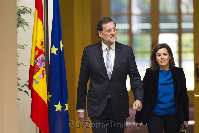 Mariano Rajoy (left), Spain’s prime minister, and Soraya Saenz de Santamaria, Spain’s deputy prime minister, arrive to attend a news conference at Moncloa palace in Madrid on Friday.    Bloomberg