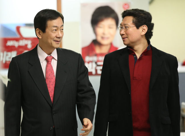 Chin Young (left), vice chairman for president-elect Park Geun-hye’s transtition team, walks with party spokesman Lee Sang-il at the party office in Yeouido, Seoul, on Sunday. Chin said he would “humbly and calmly” run the committee once all the members are named.   Yonhap News