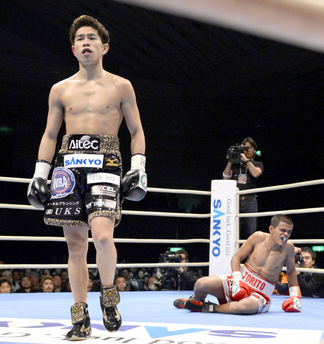 Kazuto Ioka of Japan walks toward a neutral corner after knocking down Jose Rodriguez of Mexico in the first round of their scheduled 12-round WBA light flyweight boxing title bout at Bodymaker Colosseum Osaka on Monday.   AP-Yonhap News