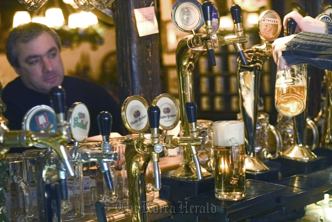 A customer enjoys a drink at a bar in Moscow.    Bloomberg