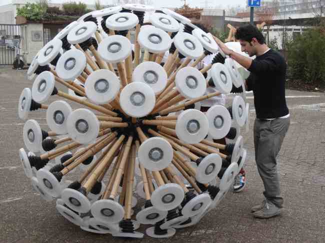 Mahmud Hassani pushes the “mine kafon,” a wind-driven gadget to clear anti-personnel mines, at an Eindhoven workshop.   AFP-Yonhap News
