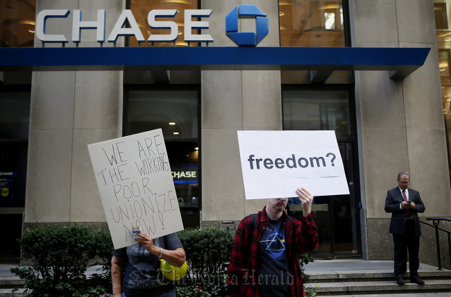 Occupy Wall Street protesters stand outside of a JPMorgan Chase & Co. bank branch during a demonstration in New York.   Bloomberg