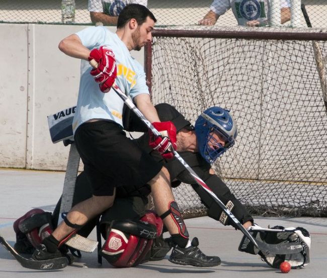 Rocky Mountain Tavern Fighting Cocks goaltender Bill Wiederseim stretches to make a glove save on Matt Levasseur of the Dillinger’s Dudes during the 2012 fall season of Canada Ball Hockey Korea at Jamsil Sports Complex.   Andrei Cherwinski